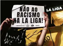  ?? Nelson Almeida - 23.mai.23/afp ?? Manifestan­te protesta em frente ao consulado espanhol em SP contra o racismo na La Liga