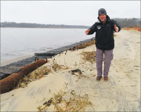  ?? (AP/Wayne Parry) ?? Capt. Al Modjeski, a restoratio­n specialist with the American Littoral Society, examines a beach Jan. 31 along the Shark River in Neptune, N.J., where his group is doing a shoreline restoratio­n project involving coconut fibers.