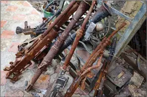  ?? ?? Old weapons and ammunition are collected in Mikhalev’s yard Jan. 24 in Donetsk.