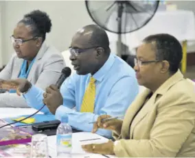  ?? (Photo: JIS) ?? Minister of Education, Youth and Informatio­n Senator Ruel Reid (centre) fields questions from educators at a regional teachers’ consultati­on held on Tuesday at the Port Antonio High School in Portland. He is flanked by Chief Education Officer Dr Grace Mclean (left) and Assistant Chief Education Officer Winnie Berry.