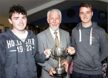  ??  ?? Cllr. Jim Moore presenting Bill Crowdle and Gary Murphy with the trophy for most wins for the New Ross Parks camp.