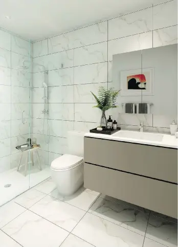  ??  ?? Bathrooms have large-format porcelain tiles along the walls and floors, “floating” vanities with quartz countertop­s and porcelain undermount sinks. The two- and three-bedroom homes come with white soaker bathtubs.