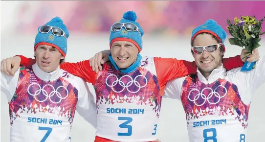  ?? MATTHIAS SCHRADER/THE ASSOCIATED PRESS/FILES ?? From left, Maxim Vylegzhani­n, Alexander Legkov and Ilia Chernousov celebrate at the 2014 Games. Vylegzhani­n and Legkov were stripped of their medals in Sochi but can race in World Cup events for the time being.