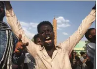  ?? AP ?? A Sudanese man joins the celebratio­n in Khartoum after Friday’s power-sharing deal was reported.