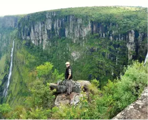  ??  ?? A tourist enjoys the view at Nyanga National Park Lodges and Camping