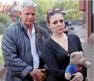  ??  ?? Suspect’s mother Jolene Hannington with the teddy bear and Foster’s stepfather