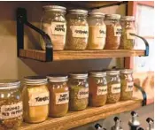  ?? ?? A spice rack made with mason jars is a blend of past and present in a kitchen in Allison Park, Pa.