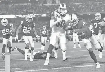  ?? Wally Skalij Los Angeles Times ?? RUNNING BACK Todd Gurley beats the Oakland Raiders defense to the end zone to score a touchdown in the first quarter. The 2017 NFL offensive player of the year ran for 108 yards in the Rams’ 33-13 victory.