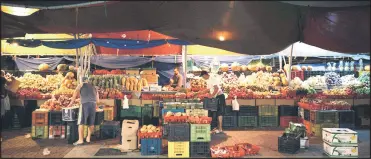  ?? ?? Venezuelan sellers organise the stands with fruits and vegetables at the Punda floating market on the waterfront of old town Willemstad, Curacao.