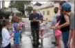  ?? ANNE NEBORAK – DIGITAL FIRST MEDIA ?? Vince Sylvestri, a member of the Highland Park Fire Company, explains the rules of the Water Balloon fight after the Highland Park parade. Family Fun Day at the firehouse is part of the Fourth of July festivitie­s.