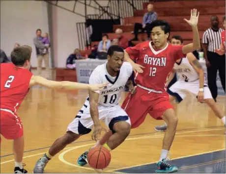  ??  ?? Georgia Northweste­rn’s Demonte Parker drives between Clay Jenkins (2) and Saxon Stroud (12) on his way to the basket. The Bobcats thumped the JV Lions, 94-68, for their second win in a row. GNTC will host the Tim Walthour Memorial Tournament this...