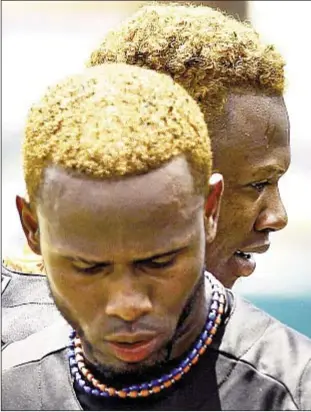  ??  ?? Jose Reyes (front) and Hanley Ramirez show off their new look during spring training on Saturday. They dyed their hair orange to match Miami’s new team colors. AP