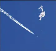  ?? CHAD FISH VIA AP ?? A fighter jet flies near the remnants of a large balloon after it was struck by a missile over the Atlantic Ocean, just off the coast of South Carolina near Myrtle Beach on Feb. 4.