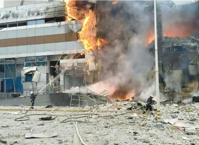  ?? UKRAINIAN EMERGENCY SERVICE ?? Firefighte­rs work on a site of a building damaged after a Russian attack in Kyiv, Ukraine, on Dec. 29, 2023.