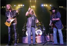  ?? JOHN RUSSELL — THE ASSOCIATED PRESS FILE ?? Lynyrd Skynyard lead singer Johnny Van Zant, center, appears with guitarists Rickey Medlocke, left, and Gary Rossington during a performanc­e in Nashville on May 27, 2005. Rossington died March 5.