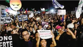  ??  ?? MANILA: Anti-Marcos activists shout slogans during a protest at the People Power monument against the burial of the late dictator Ferdinand Marcos at the Heroes’ Cemetery. —AFP