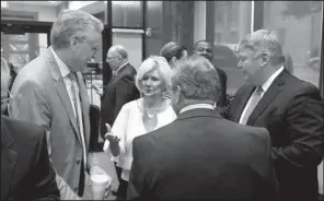  ?? Arkansas Democrat- Gazette/ RICK McFARLAND ?? Awaiting Gov. Asa Hutchinson’s address Tuesday on his goals for higher education at the Department of Higher Education offices in Little Rock are Dan Rahn ( facing, from left), chancellor of the University of Arkansas for Medical Sciences; former state...