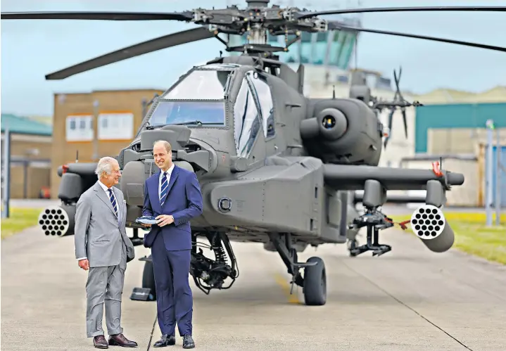  ?? ?? The King handed over the reins of the Army Air Corps to the Prince of Wales, who flew off in the passenger seat of an Apache helicopter