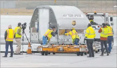  ?? Matthew Dae Smith The Associated Press ?? Boxes of some of the first shipments of the Pfizer-biontech COVID-19 vaccines are transporte­d on the tarmac Sunday at Capital Region Internatio­nal Airport in Lansing, Mich., to be loaded onto a jet for nationwide distributi­on.