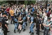  ?? Pavel Golovkin / Associated Press ?? Police and hundreds of demonstrat­ors faced off in Moscow over police abuse in the wake of the high-profile detention of a Russian journalist.