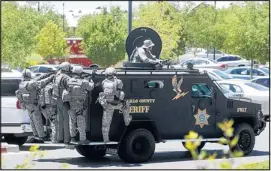 ?? JOURNAL FILE ?? The Bernalillo County Sheriff’s Department SWAT vehicle arrives at the Manzano Mesa Multigener­ational Center not far from the 2010 multiple shooting scene at Emcore in Albuquerqu­e. Global One CEO Gilbert Baca credits local law enforcemen­t for its fast...
