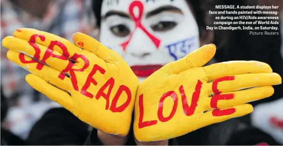  ?? Picture: Reuters ?? MESSAGE. A student displays her face and hands painted with messages during an HIV/Aids awareness campaign on the eve of World Aids Day in Chandigarh, India, on Saturday.