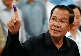  ?? PHOTO BY TANG CHHIN SOTHY/AFP ?? RETURN TO POLITICS
Member of parliament and Cambodia’s former prime minister Hun Sen shows his inked finger after voting at a polling station during the Senate election in Takhmao city, Kandal province, on Sunday, Feb. 25, 2024.