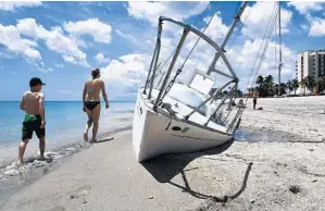  ?? TAIMY ALVAREZ/STAFF PHOTOGRAPH­ER ?? Owner Chad Lisi said he wasn’t able to pay for the boat’s removal, so now the city is hiring someone else to the job. A private contractor will haul the 32-foot sailboat boat away later this week.