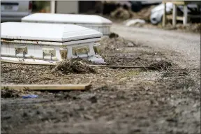  ?? GERALD HERBERT — THE ASSOCIATED PRESS ?? Caskets that floated from their tombs during flooding from Hurricane Ida sit Sept. 27 along a roadside in Ironton, La.