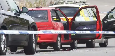  ??  ?? Battered: Smashed windows and bullet holes show the onslaught of shots fired at the car