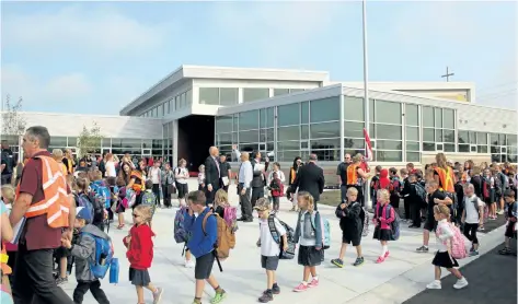  ?? ALLAN BENNER/STANDARD STAFF ?? Hundreds of students at St. Martin Catholic School in West Lincoln walk into their new school for the first time on Tuesday.