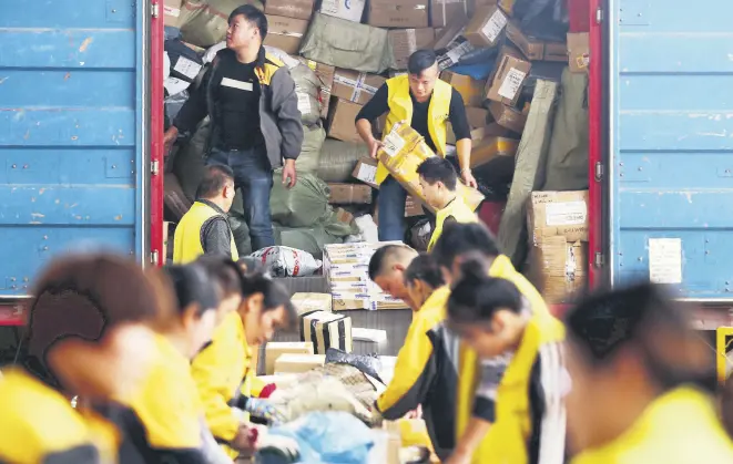  ??  ?? Employees sort packages ahead of Singles Day in Huaibei, China’s eastern Anhui province.