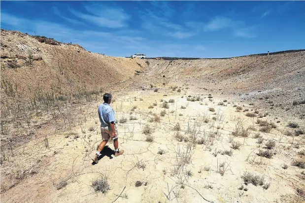  ?? Picture: Esa Alexander ?? Farmer Gideon van Zyl in one of his empty earth dams in Vredendal, in the Western Cape, where almost all the dams are dry.