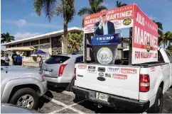  ?? ?? An image of former President Donald Trump along with posters for mayoral candidate Julio
Martinez on a truck in the parking lot of the John F. Kennedy Library in Hialeah during early voting on Oct. 27.
