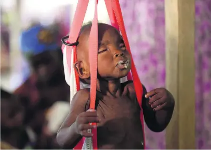  ?? Sunday Alamba / AP Photo ?? A child is weighed on a scale at a clinic run by Medecins Sans Frontieres in Maiduguri, Nigeria. Up to 50 per cent of children suffer malnutriti­on in parts of the region. Unicef says Dh422 million is needed to save children from starving to death.