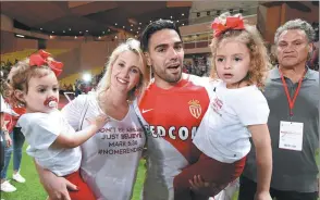  ?? JEAN-PIERRE AMET / REUTERS ?? Monaco striker Radamel Falcao celebrates with his family after Wednesday’s 2-0 victory over SaintEtien­ne sealed the club’s first French top-flight title in 17 years.