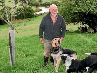  ?? PHOTO: ROB TIPA/STUFF ?? Dan Lyders with two of his working dogs Dhu and Roger. Behind him are ponds he created to provide a wildlife refuge.