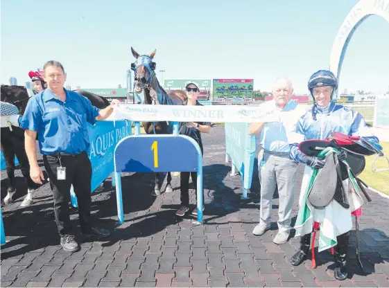  ??  ?? Trainer Les Kelly (left) celebrates after Dramatic Moments and jockey Andrew Spinks,(right) stormed home.