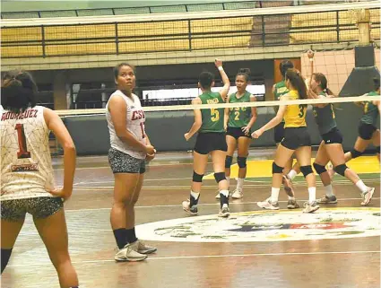  ?? SUNSTAR FOTO / RUEL ROSELLO ?? CELEBRATE, OR NOT. The University of San Carlos players (behind net) celebrate their hard-earned victory over the Cebu Spikers Volleyball Club. USC had to endure five long sets before beating CSVC, which is set to take part in the Philippine National...