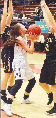  ?? Westside Eagle Observer/RANDY MOLL ?? Gentry junior Ariel Nix looks to shoot the ball while guarded by Prairie Grove seniors Lexie Madewell and Kaylee Elder during Friday’s game at Gentry High School.