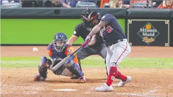  ?? ERIK WILLIAMS/USA TODAY SPORTS ?? Washington Nationals designated hitter Howie Kendrick hits a two-run home run against the Houston Astros during the seventh inning of game seven of the 2019 World Series at Minute Maid Park in Houston. The Nationals won 6-2. For full game coverage visit thestarpho­enix.com/sports.