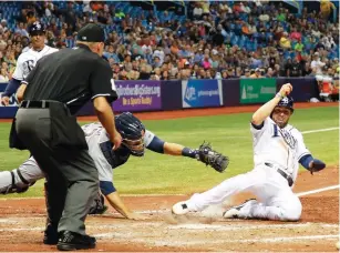  ?? (USA Today) ?? TAMPA BAY RAYS baserunner David DeJesus avoids the tag of Detroit Tigers catcher Alex Avila and slides safely into home plate for a fifth-inning run in the Rays’ 5-2 home victory on Monday night.