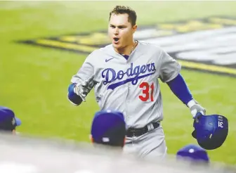 ?? KEVIN JAIRaJ/ USA TODAY SPORTS ?? Los Angeles left-fielder Joc Pederson arrives back at the dugout after hitting a solo home run to give the Dodgers a 3-0 lead over the Tampa Bay Rays early in Game 5 of the World Series.