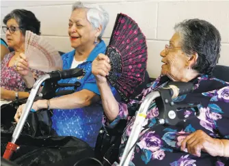  ?? Michael Macor / The Chronicle ?? Zoila Tracino (left), Elizabeth Sisniegas and Marta Phillips are fans of the cooling center at Antioch Senior Citizens Club. The senior center had live music and free meals Thursday.