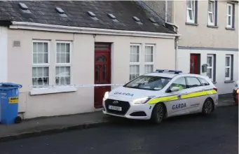  ??  ?? A Garda vehicle outside a cottage on New Road, Thomondgat­e, Limerick. Photo: Liam Burke Press 22