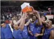  ?? CRAIG MITCHELLDY­ER — THE ASSOCIATED PRESS ?? Duke holds up the championsh­ip trophy after a victory over Florida in the Phil Knight Invitation­al tournament in Portland, Ore., Sunday.