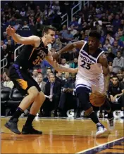  ?? ASSOCIATED PRESS ?? MINNESOTA TIMBERWOLV­ES GUARD JIMMY BUTLER (23) dribbles in the first quarter against the Phoenix Suns on Saturday in Phoenix. Coaches Corner