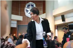  ?? AP Photo/L.M. Otero, File ?? below left
In this Sept. 7, 2017, file photo, new Dallas Police Chief U. Reneé Hall shakes hands with potential police recruits during an applicant processing event at police headquarte­rs in Dallas. Citizens in recent months have complained to Hall of...