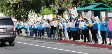  ?? MIKE BUSH/NEWS-SENTINEL ?? Teachers and supporters of Lodi Unified School District teachers hold up signs at the southeast corner of the intersecti­on of Kettleman and Ham lanes on Wednesday afternoon.