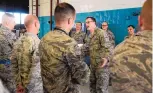  ?? GREG SORBER/JOURNAL ?? The Rev. David Dziolek, a chaplain at Kirtland Air Force Base, tells a joke to members of the 58th Special Operations Wing, who maintain C-130 transport aircraft at the base.